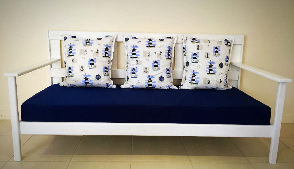 Daybed seat cushion in deep navy with Nautical themed scatters